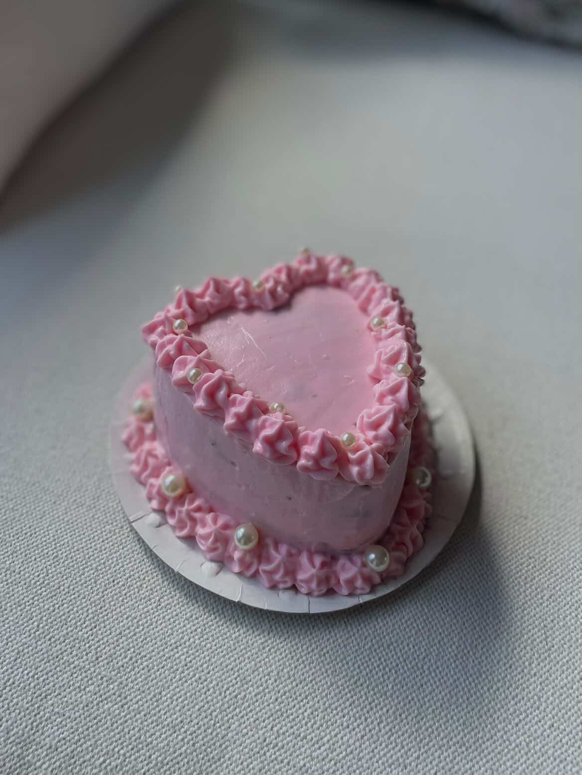Mini tarta artesanal en forma de corazón con buttercream rosa y perlas — decoración especial passedby.coda